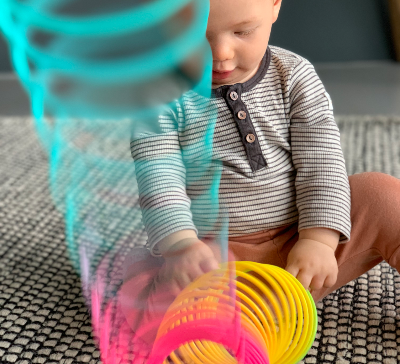 Refresh your baby’s toys to help develop new motor skills